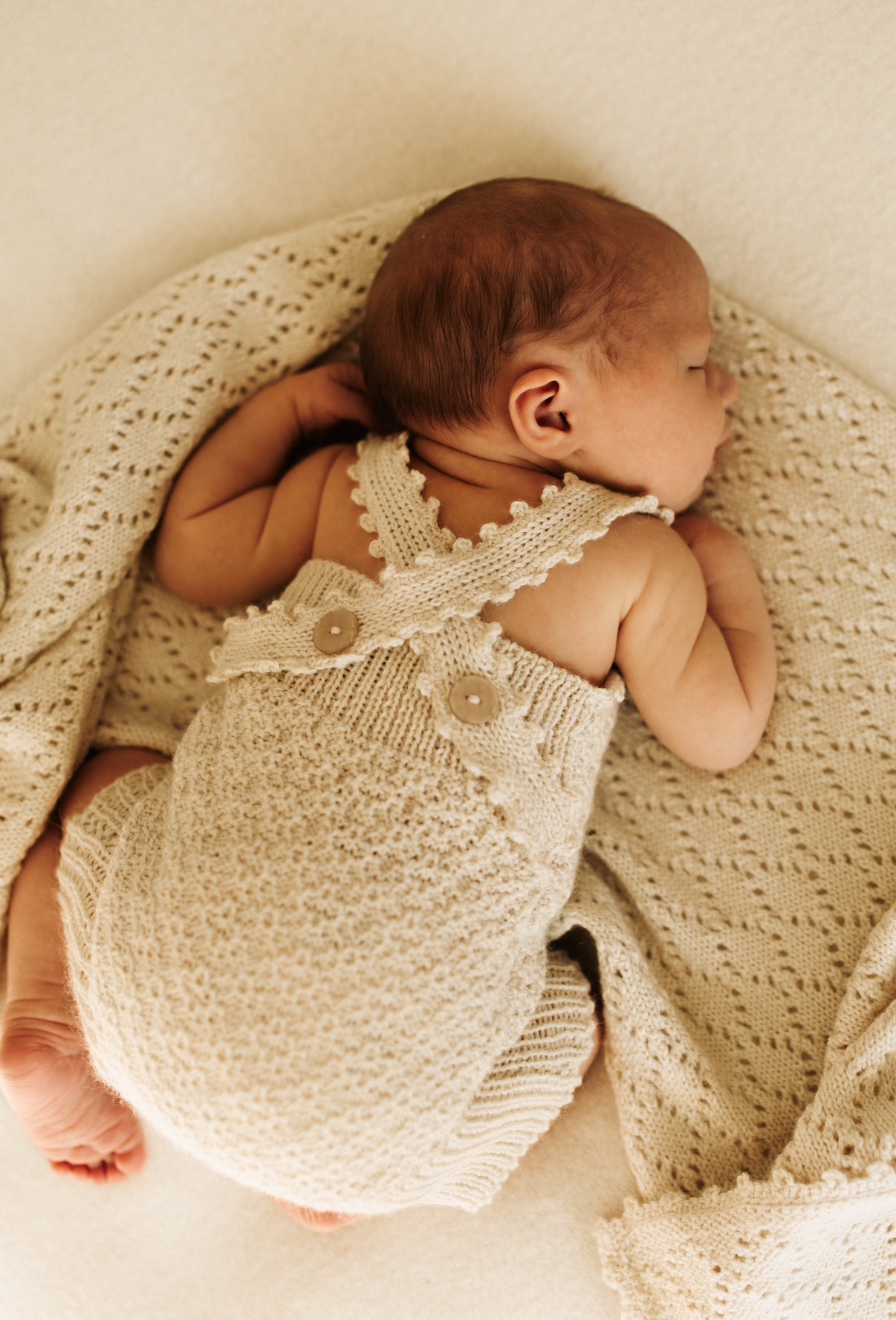 Handcrafted newborn romper made from soft, sustainable fibre. Breathable, gentle on delicate skin, and designed for comfort and warmth