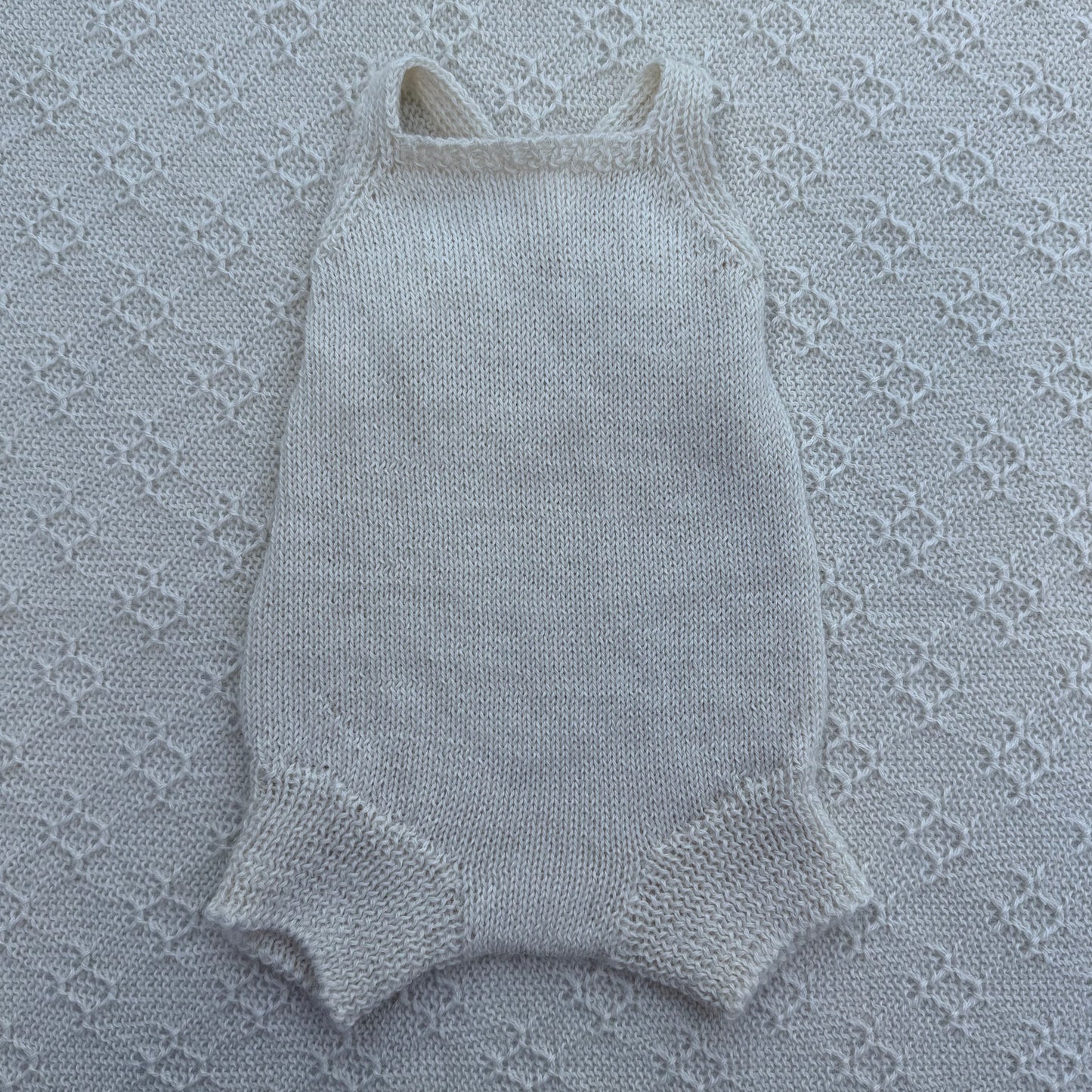 Poppy newborn alpaca romper with plain straps front