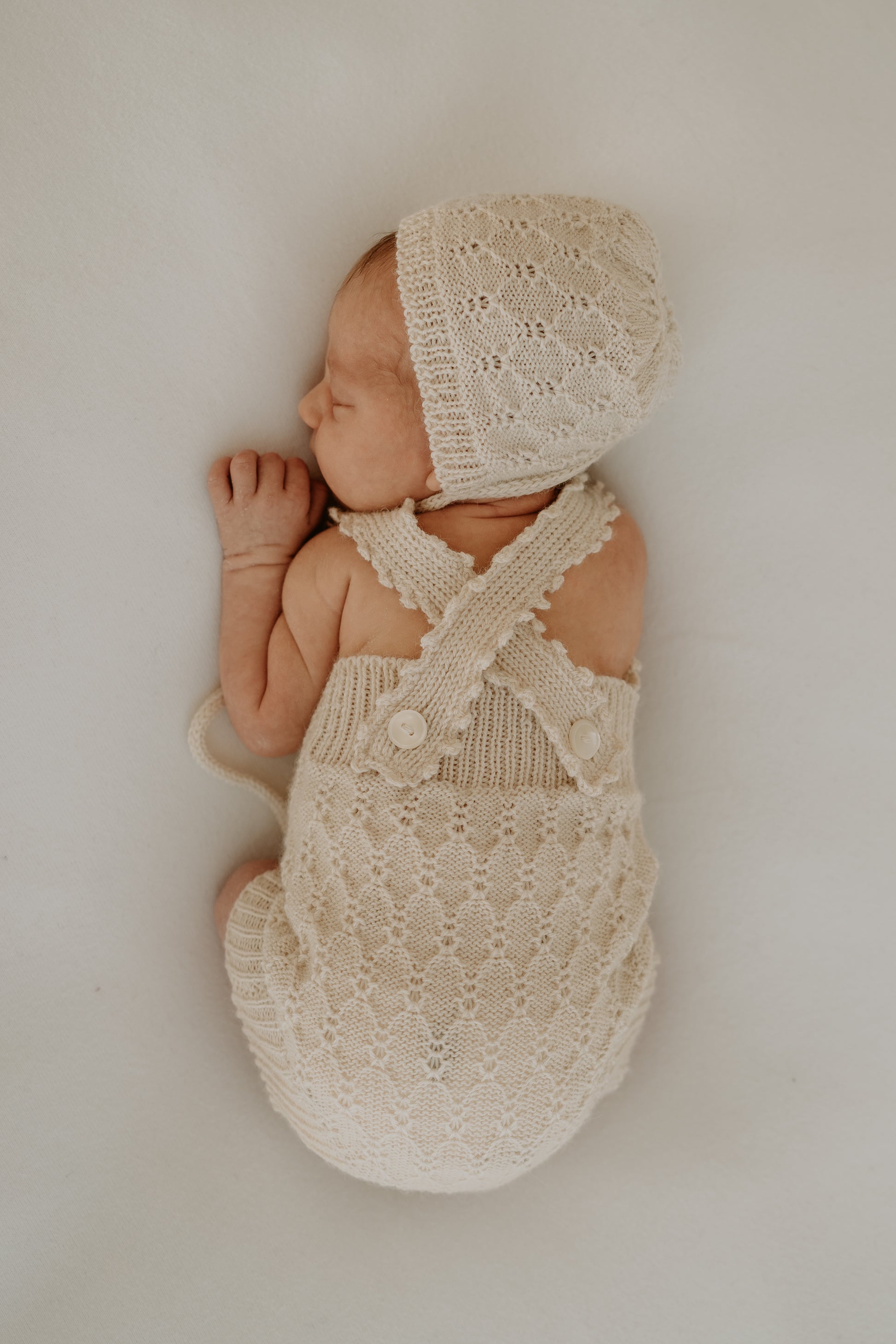 Handcrafted newborn romper made from soft, sustainable fibre. Breathable, gentle on delicate skin, and designed for comfort and warmth