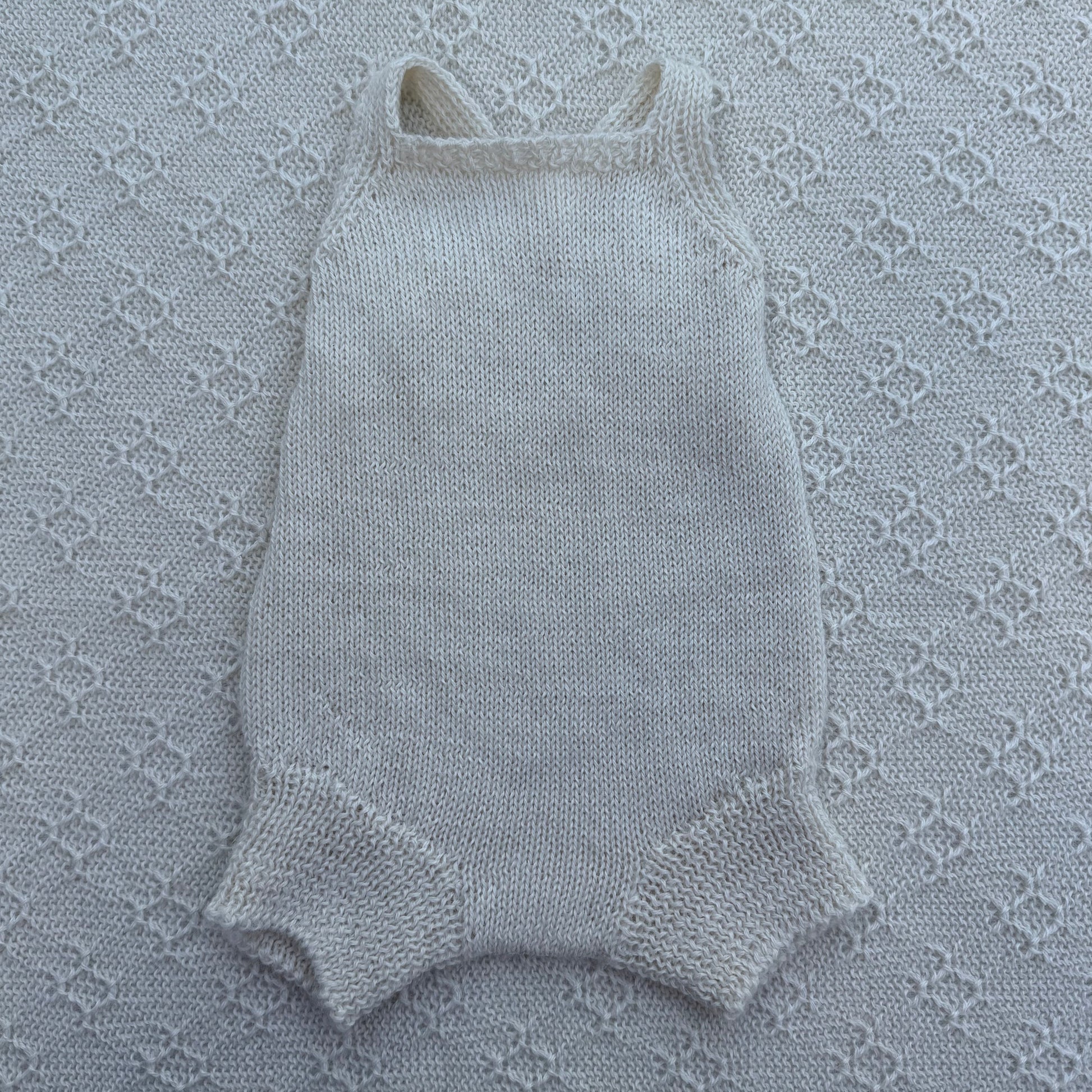 Poppy newborn alpaca romper with plain straps front